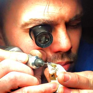 Image showing Holme Finnilä in workshop making a handmade Levenaig watch using a machine